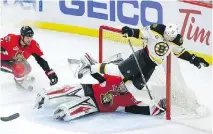 ?? FRED CHARTRAND/THE CANADIAN PRESS ?? Boston Bruins centre Sean Kuraly flies over Ottawa Senators goalie Craig Anderson Friday in Ottawa.