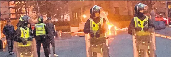  ??  ?? Riot police battle to take back control in Govan, Glasgow, on Friday night after sectarian violence flared between marchers and protesters