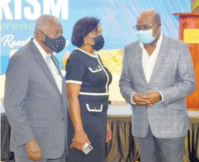  ?? CONTRIBUTE­D ?? Minister of Tourism Edmund Bartlett (right), speaks with chairman of the Tourism Enhancemen­t Fund, Godfrey Dyer and executive director of Jamaica Vacations, Joy Roberts, at the opening of the Jamaica Health and Wellness Conference on November 18, at the Montego Bay Convention Centre, St James.