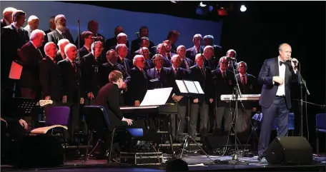  ??  ?? St Peters Choir on stage with conductor Edward Holly at the tribute to Larry Delaney show in The Barbican Centre.