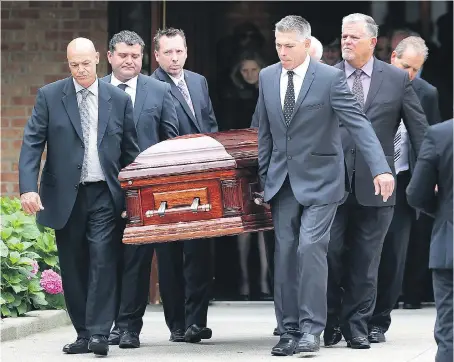  ?? PHOTOS: DAN JANISSE ?? Pallbearer­s carry the casket of Mark Boscariol after funeral service Wednesday at Our Lady Of Mount Carmel Church in Windsor. The popular restaurate­ur and city champion died last Thursday at age 51.