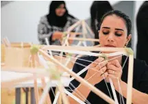  ?? Elizabeth Conley / Houston Chronicle ?? Samira Houshmand ties string while building lamps for an art installati­on, “Green Light,” by Danish artist Olafur Eliasson at Rice University’s Moody Center.