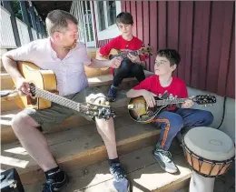  ?? PETER McCABE ?? Tim Walsh, left, jams with budding musicians Kyle and Nilan VergnanoMc­rae on Saturday. The youth jam is open to young musicians who can play even a few basic chords on the guitar, mandolin or banjo.