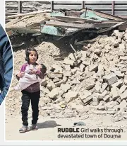  ??  ?? RUBBLE Girl walks through devastated town of Douma