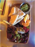  ?? ?? The marinated olive platter is served with pita and pesto sauce, and is perfect for nibbling.