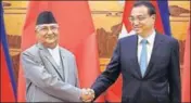  ?? REUTERS ?? Nepal's Prime Minister KP Sharma Oli shakes hands with Chinese Premier Li Keqiang during his visit to China on Thursday.