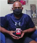  ?? Photo: Leon Lord ?? An emotional Suliasi Wasakitoga holding a photo of his son Luke Sulinibau at their home in Raiwaqa on September 5, 2021.