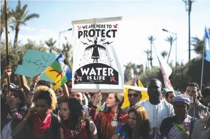  ??  ?? MARRAKECH: Hundreds protest against climate change and urge world leaders to take action, in a march coinciding with the Climate Conference, known as COP22, taking place in Marrakech, Morocco. — AP