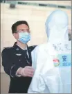  ?? PROVIDED TO CHINA DAILY ?? Wu Ge (left) leads a team at Shanghai Pudong Internatio­nal Airport tasked with COVID-19 prevention and control.