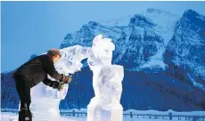  ??  ?? An ice sculptor works on his display during the 2018 Ice Magic Festival.