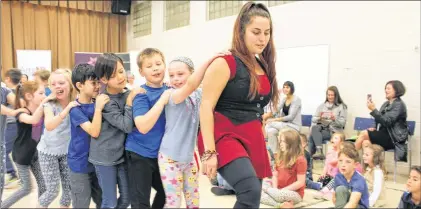  ?? SAM MCNEISH/THE TELEGRAM ?? Rebecca Sharr of Eastern Owl leads students of St. Mary’s Elementary through the snake dance as part of the Artssmarts program that announced grants for a variety of programs across the province and the 2017 Statoil Artssmart Scholarshi­p winner.