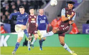  ??  ?? Leicester’s Jamie Vardy and Villa’s Tyrone Mings tangle in the first leg