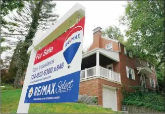  ?? ?? A for sale sign is displayed outside a home in Mount Lebanon, Pennsylvan­ia, on Tuesday, Sept. 21, 2021. (AP)