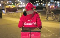  ?? KRISZTIAN BOCSI/BLOOMBERG ?? Foodora delivery couriers will be bringing customers junk food and everyday essentials such as milk and bread.