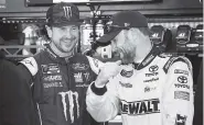  ??  ?? Drivers Kurt Busch, left, and Matt Kenseth joke around in the garage during practice Friday. Busch is coming off a win in the season-opening Daytona 500 that gave Stewart-Haas Racing a strong showing in its switch to Ford.