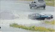  ?? HAMILTON SPECTATOR FILE PHOTO ?? Heavy rains flooded the Red Hill Valley Parkway, July 9, 2010, at the King Street overpass. A hatchback which hydroplane­d into the median is hit from behind by another vehicle.