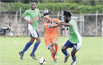  ?? FILE ?? Ronaldo Rodney (left) of Montego Bay United (MBU) looks on while teammate Owayne Gordon is pushed off the ball by Dane Spence of Sandals South Coast in their Red Stripe Premier League 0-0 encounter at the STETHS Sports Complex in St Elizabeth on...