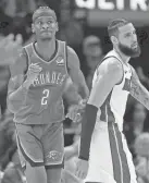  ?? SARAH PHIPPS/THE OKLAHOMAN ?? Thunder guard Shai Gilgeous-Alexander (2) celebrates next to the Heat's Caleb Martin in OKC's 107-100 win Friday at Paycom Center.