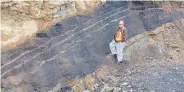  ??  ?? A project manager checks a coal seam in the Raven coalfield near Comox in this 2009 photo.
