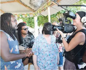  ??  ?? A member of the Person of Interest reggae band being interviewe­d.