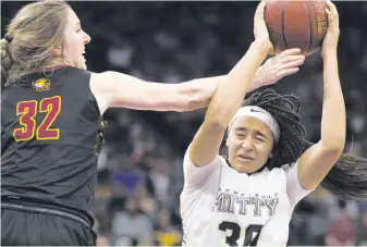  ?? Photos by D. Ross Cameron / Special to The Chronicle ?? Clovis West’s Tess Amundsen tries to knock the ball out of the hands of Mitty’s Haley Jones during the fourth quarter of their Open Division state championsh­ip game.