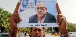  ?? PHOTO: REUTERS ?? A relative of the Jordanian writer Nahed Hattar holds his picture during a sit-in in the town of Al-Fuheis near Amman, Jordan.