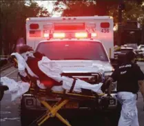  ?? MARK LENNIHAN, THE ASSOCIATED PRESS ?? Emergency personnel transport a man on a stretcher after a motorist drove onto a busy bicycle path near the World Trade Center memorial and struck several people at about 3 p.m. Tuesday in New York.