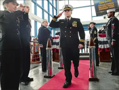  ?? PHOTOS BY DANA JENSEN THE DAY ?? Lt. Cmdr. Bradley Boyd salutes as he exits the change of charge ceremony relieving Lt. Cmdr. Reginald Preston as the officerin-charge of the Historic ship Nautilus (SSN 571) and director of the Submarine Force Museum. The ceremony took place in the...