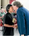  ?? ALLAN WILSON CENTRE ?? The people who went their different ways somewhere in the Middle East 60,000 years ago, came together again in Aotearoa. Here, Tolaga Bay Area School student Rewi Castle thanks Professor Hamish Spencer of the University of Otago for the DNA research...