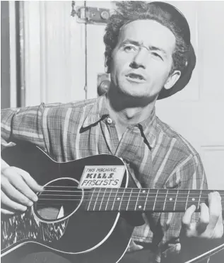 ?? AL AUMULLER/NEW YORK WORLD-TELEGRAM & SUN ?? Woody Guthrie wrote an immense number of songs, and more than songs, besides drawing and painting. The archive of his work includes scores of journals, diaries and letters.