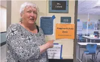  ??  ?? ABOVE: Barshia Cohee, a language arts and special-education teacher at Capital High School, gestures toward a fragrancef­ree sign outside her classroom.