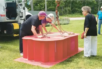  ?? CARRIE NAPOLEON /POST-TRIBUNE ?? Artist Ruth Aizuss Migdal, right, oversees the installati­on of her sculpture Here in Marquette Park in Gary. The piece is one of three in a new public art exhibit in the city.