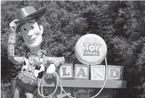 ?? AP PHOTO BY JOHN RAOUX ?? A statue of the character Sheriff Woody greets visitors at the entrance to Toy Story Land in Disney’s Hollywood Studios at Walt Disney World in Lake Buena Vista, Fla.