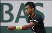  ?? MICHEL EULER — THE ASSOCIATED PRESS ?? Felix Auger-Aliassime, trained by Rafael Nadal's uncle and former coach, will face Nadal in the French Open fourth round.