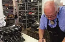  ??  ?? John Lewis, a typewriter repairman, works at his shop in Albuquerqu­e, NM, in front of his collection of vintage typewriter­s.