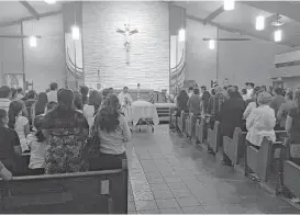  ?? Andrew Kragie / Houston Chronicle ?? Family and friends gather Tuesday at Conroe’s Sacred Heart Catholic Church for the funeral of Adan Hilario Jr., 11, who died on June 19 during a police chase.