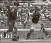  ?? / AP - John Amis ?? Arizona Diamondbac­ks’ Patrick Corbin, left, watches Atlanta Braves catcher Kurt Suzuki, right, throw his bunted ball to third base for a double play with Daniel Descalso out at third during the third inning Sunday in Atlanta.