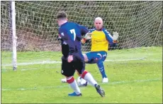  ??  ?? Fraser MacFarlane knocks the ball through Neilston keeper Gareth Fulton’s legs to give Saints the lead.