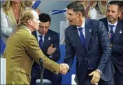  ?? ?? Team USA captain Steve Stricker (left) greets Team Europe captain Padraig Harrington on Thursday at Whistling Straits in Sheboygan, Wisconsin.