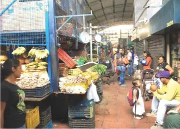  ?? — Reuters/ Washington Post photos ?? The situation is critical, says Nancy Rodríguez, who runs a produce stand at the Quinta Crespo market in Caracas, Venezuela.