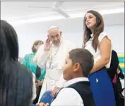  ?? Tony Gentile AFP/Getty Images ?? IN EAST HARLEM, the pontiff visits Our Lady Queen of Angels school, where students sang to him.