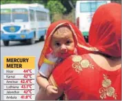  ??  ?? A woman tries to protect her child from the scorching heat at the Rohtak bus stand on Monday. MANOJ DHAKA/HT