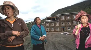  ?? — AFP photos ?? Sixty-year-old matriarch Dolma Lhamo (centre) with her daughters standing in front of a house in Zhaba.The small matrilinea­l Zhaba ethnic group of Sichuan province eschew monogamous relationsh­ips for traditiona­l “walking marriages”.