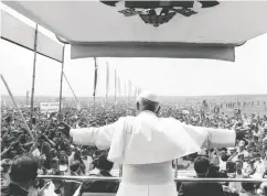  ?? Keystone / Gett y Imag es files ?? Pope John Paul II rides in the Pope-mobile on an eight- day visit to Poland in June 1979.