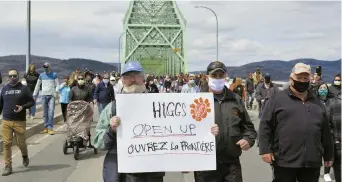  ??  ?? Des centaines de personnes des deux côtés de la Restigouch­e ont marché sur le pont J.C. Van Horne, lundi, afin de réclamer l’ouverture de la frontière entre le Restigouch­e et la région Avignon-Ouest, en Gaspésie. - Acadie Nouvelle: Jean-François Boisvert