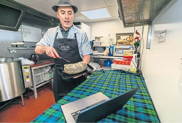  ?? Picture by Steve Brown. ?? SLICE OF TRADITION: Burntislan­d butcher Tom Courts practising his address to a haggis for the online Burns supper.