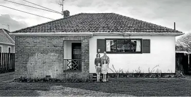  ??  ?? It could be the 50s, but this photograph shows the original ex-state house in Sandringha­m bought by Richard and Rebecca Furze, pictured with daughters Claudia and Billie.