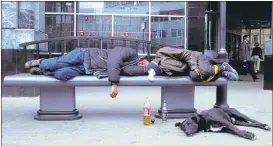  ?? ALEXEI SAZONOV/ASSOCIATED PRESS ARCHIVES ?? Men sleep with bottles of drink near-at-hand, on a bench in Moscow in a 2005 photo. Some Russian officials this week are daring to think the seemingly unthinkabl­e in the land of vodka of banning the sale of alcohol once a week in the country’s two main...