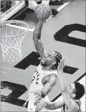  ?? FRANK GUNN/AP ?? Kawhi Leonard gets past the Bucks’ Malcolm Brogdon for a dunk during the second OT of the Raptors’ win.