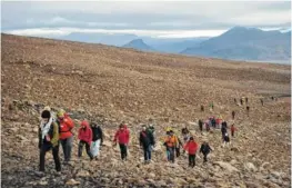  ?? AP PHOTO/FELIPE DANA ?? People climb Sunday to the top of what once was the Okjokull glacier, in Iceland.